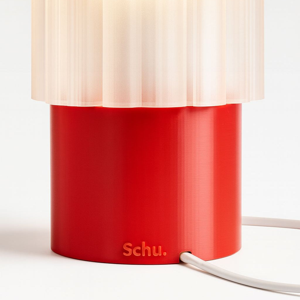 Red lamp with a white shade on a light background